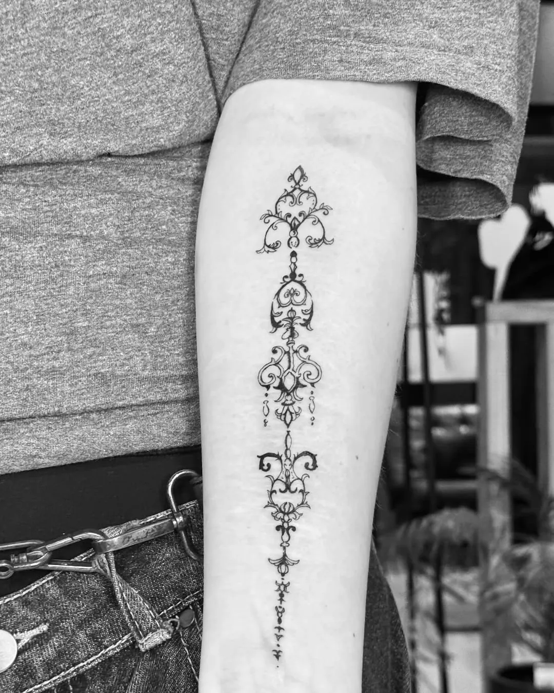 Fine line ornamental forearm tattoo