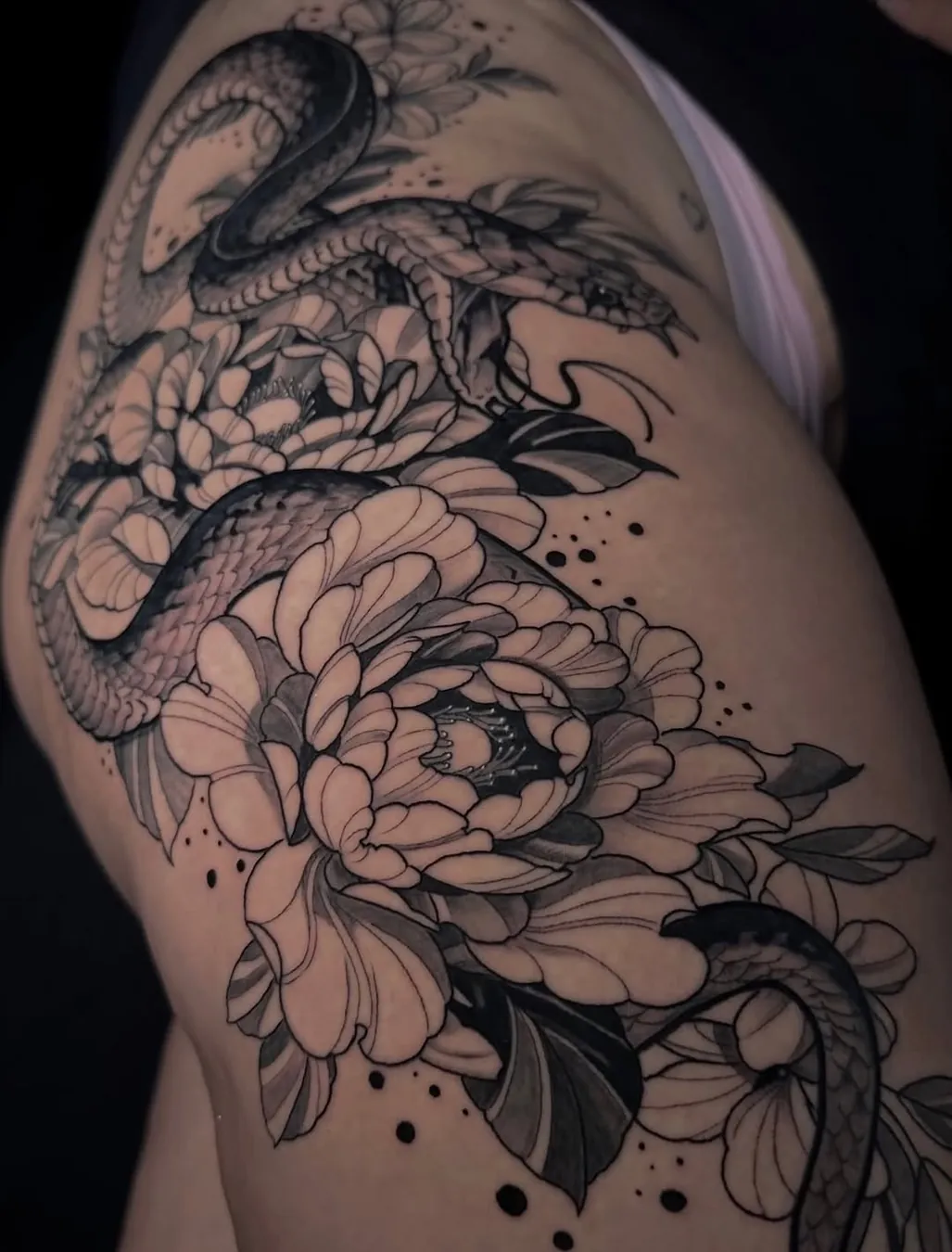 Snake and peony blackwork on hip