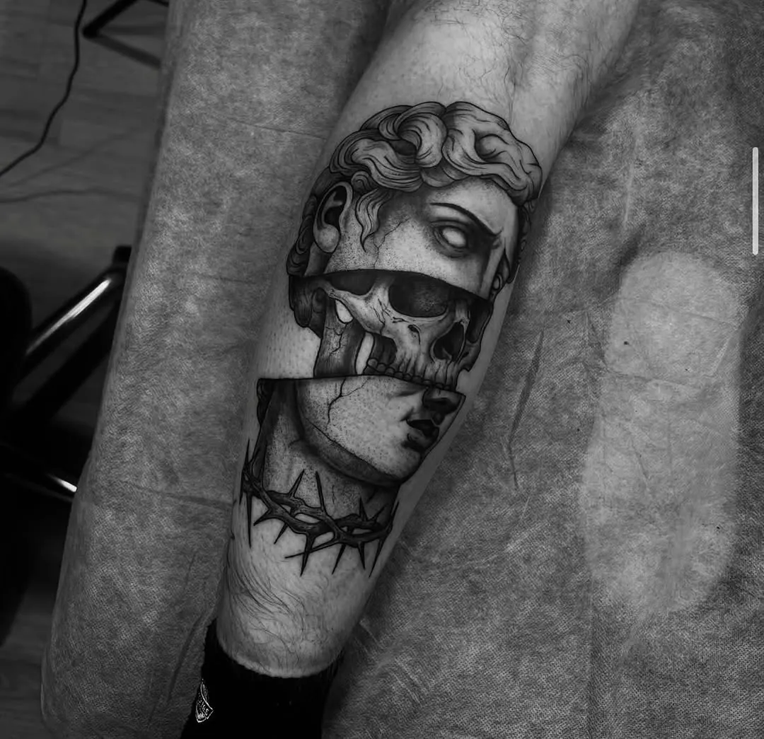 Classical statue and skull on forearm