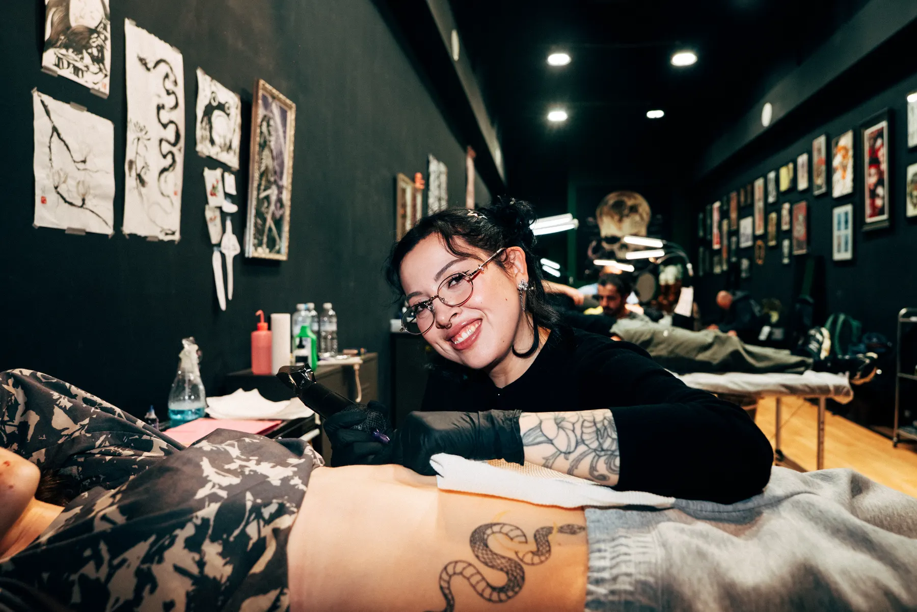 A Full Moon artist smiling mid session at 283 Chapel Street, Prahran
